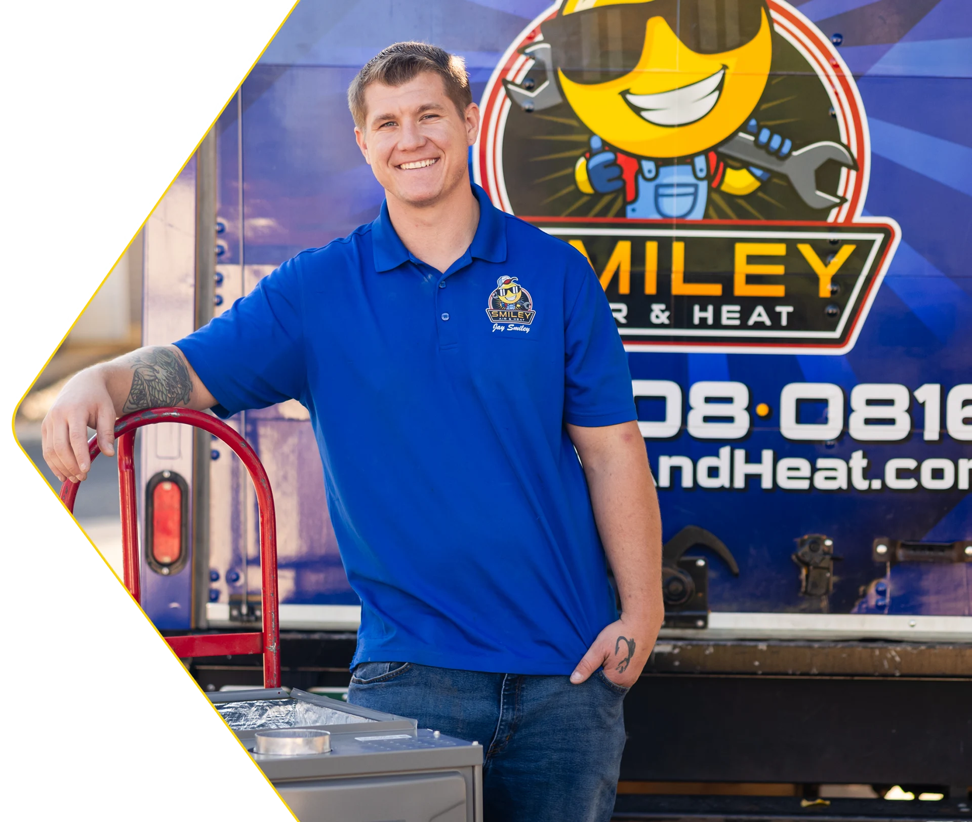 A man standing in front of a smiley logo.